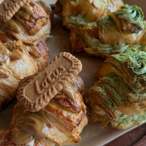 Close-up of Sunny Cafe's croissants, some with Lotus Biscoff and others with green matcha cream.
