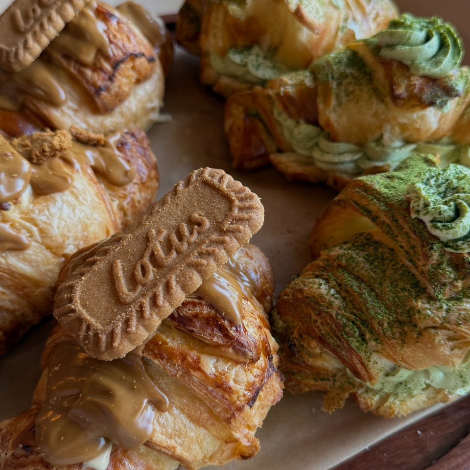 Close-up of Sunny Cafe's croissants, some with Lotus Biscoff and others with green matcha cream.